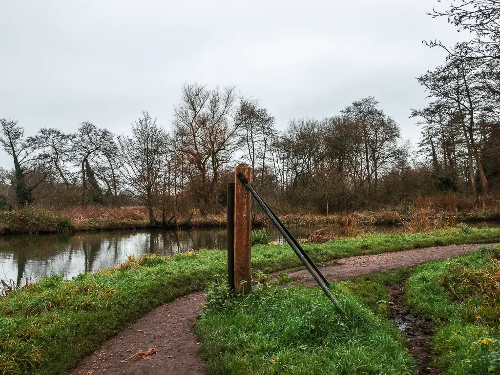 A wooden and metal roller on the river bend.