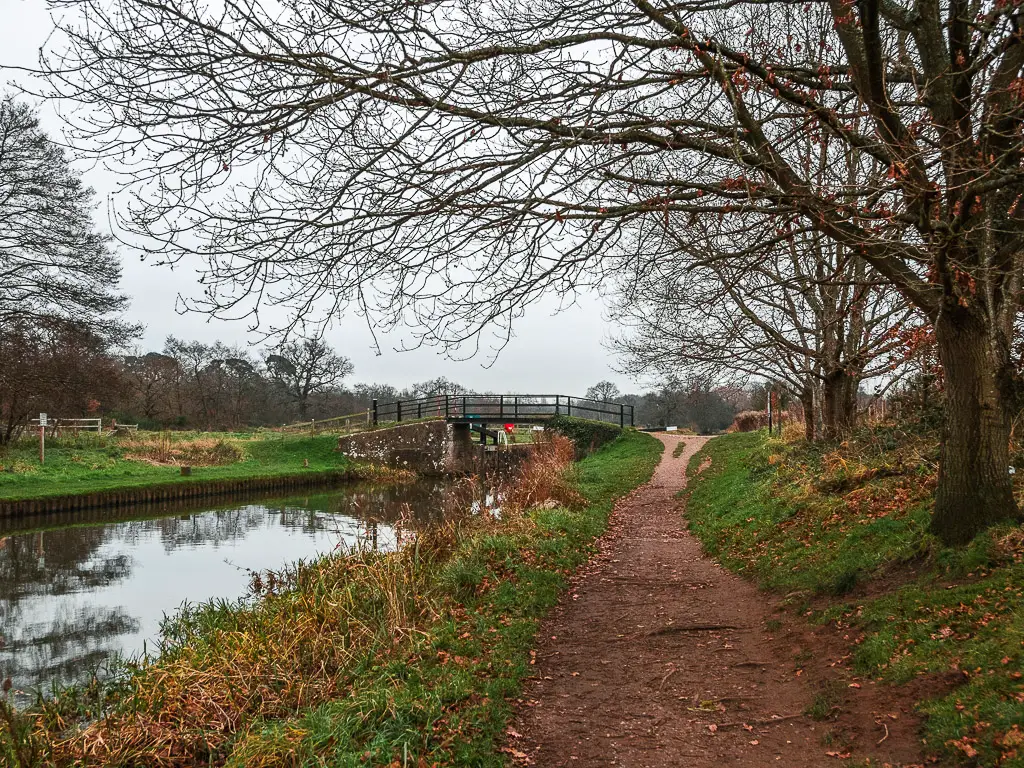 The dirt trail leading to a bridge crossing.