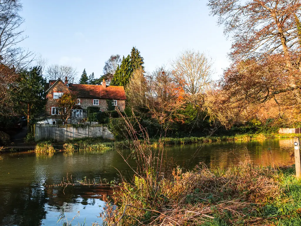 Looking across the River Wey to a cute house on the other side at the start of the circular walk from Guidlford towards St Martha's Hill and Newlands Corner. 