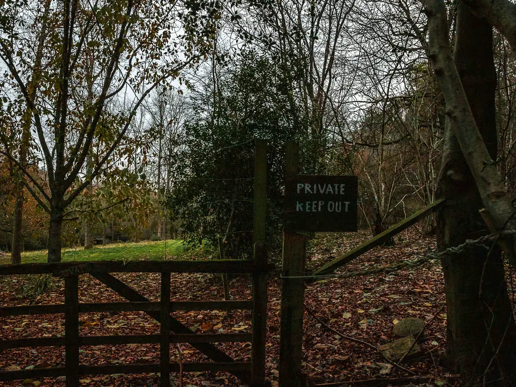 A wooden gate with a sign that says 'private, keep out'.