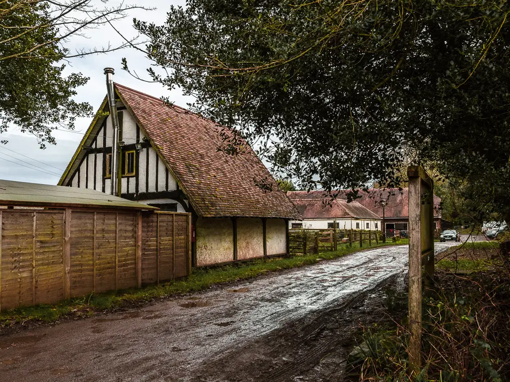 A road running next to a farm building.