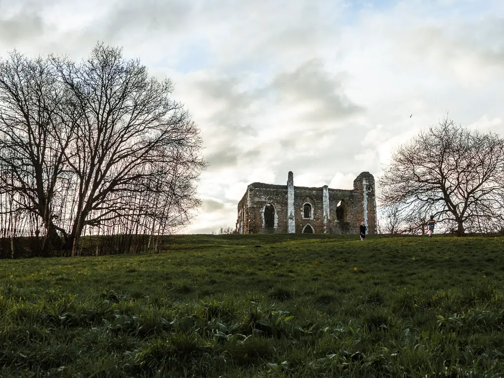The ruins of St catherine's Chapel on top of a green grass hill at the start of the walk from Guidlford to Westhumble.