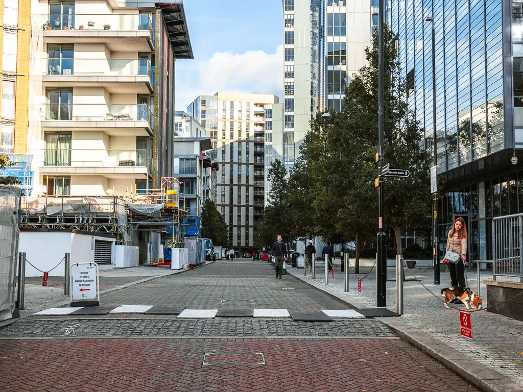 Looking down the road in between all the tall apartment buildings. 