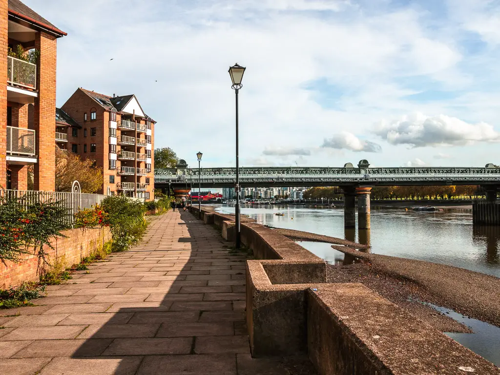 Looking along the Thames Path to Fulham Railway Bridge, on the walk from Putney to Battersea.