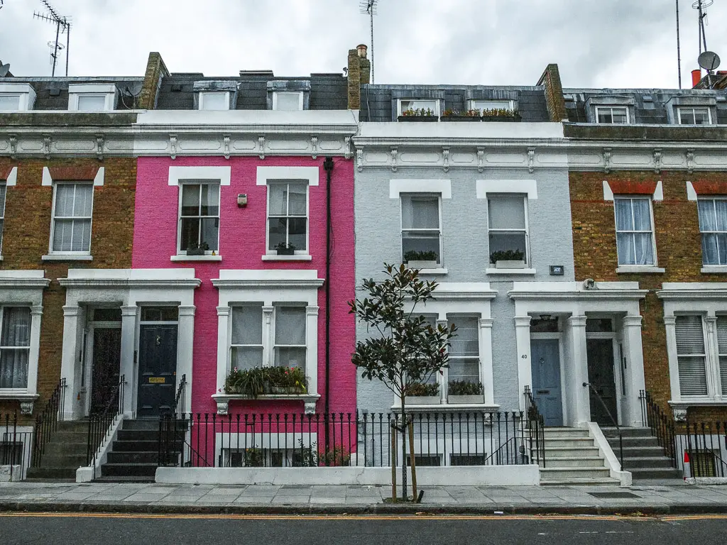 Pink, grey and brown facades of some houses.