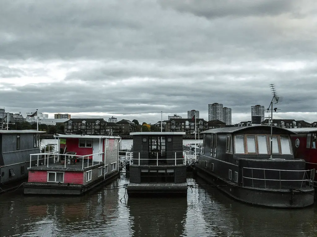 Boat houses on the River Thames towards the end of the Thames Path walk from Putney to Battersea. 