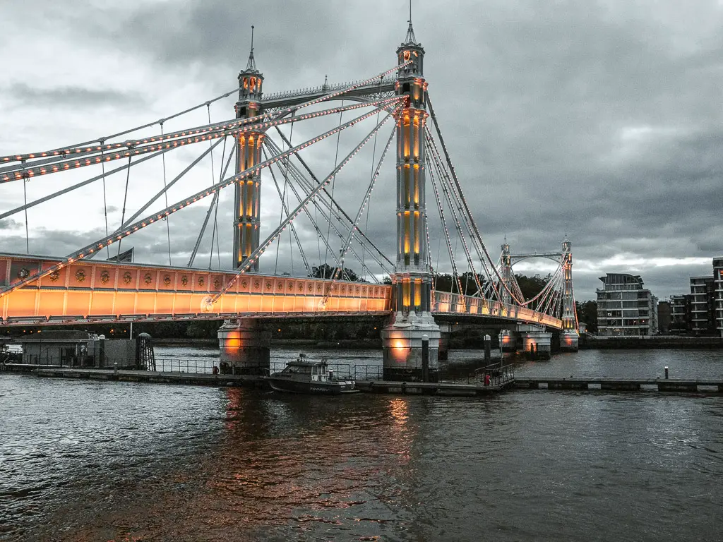 The brightly lit up Albert Bridge as it runs across the River Thames to Battersea, at the end of the walk from Putney along the Thames Path.