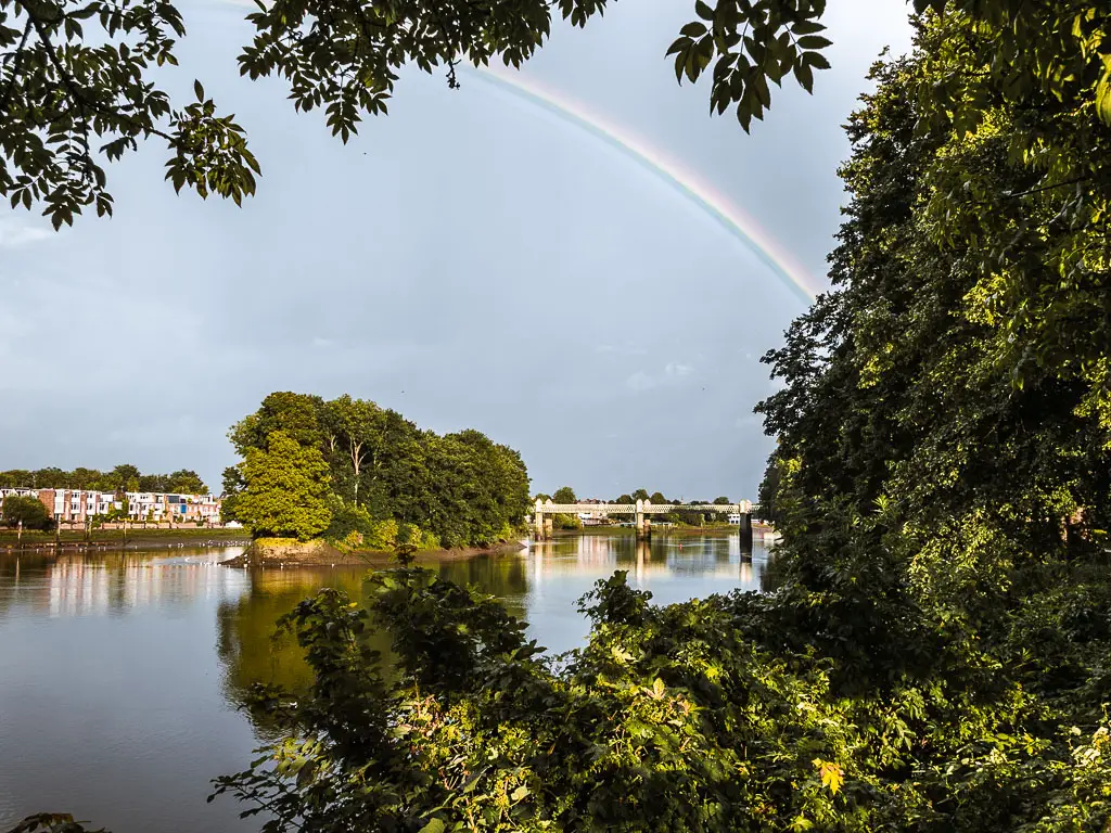 A rainbow over an island on the river on the walk between Richmond and putney along the Thames Path.