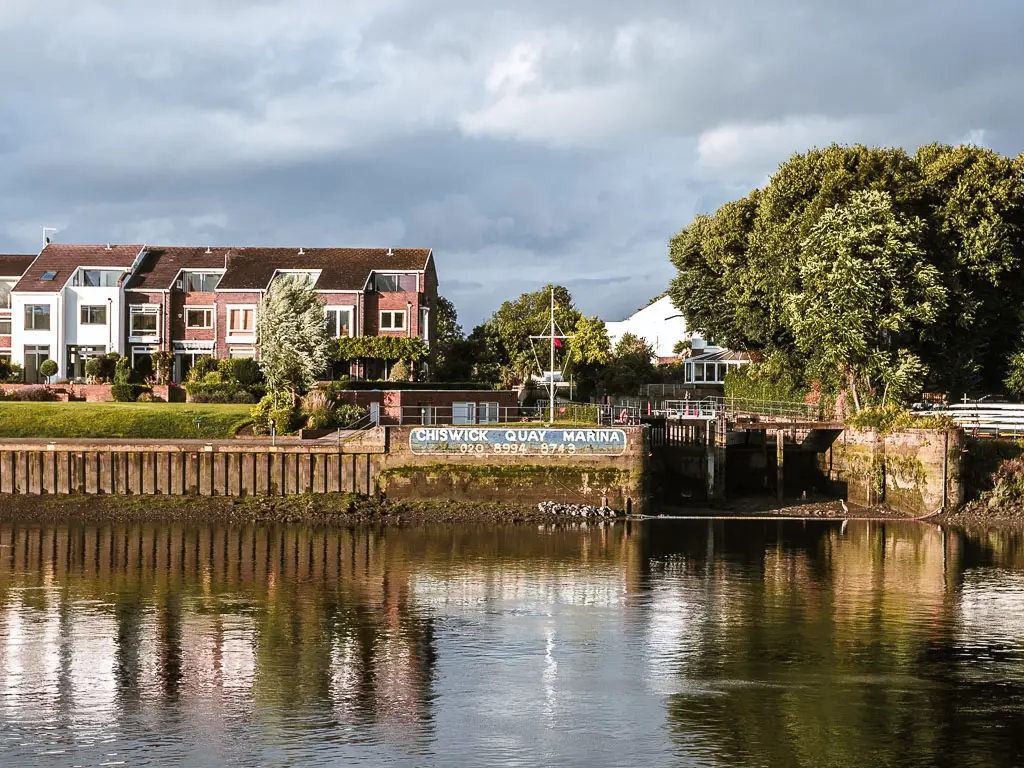 Looking across the river to the Chiswick Quay marina on the walk from Richmond to Putney along the Thames Path.