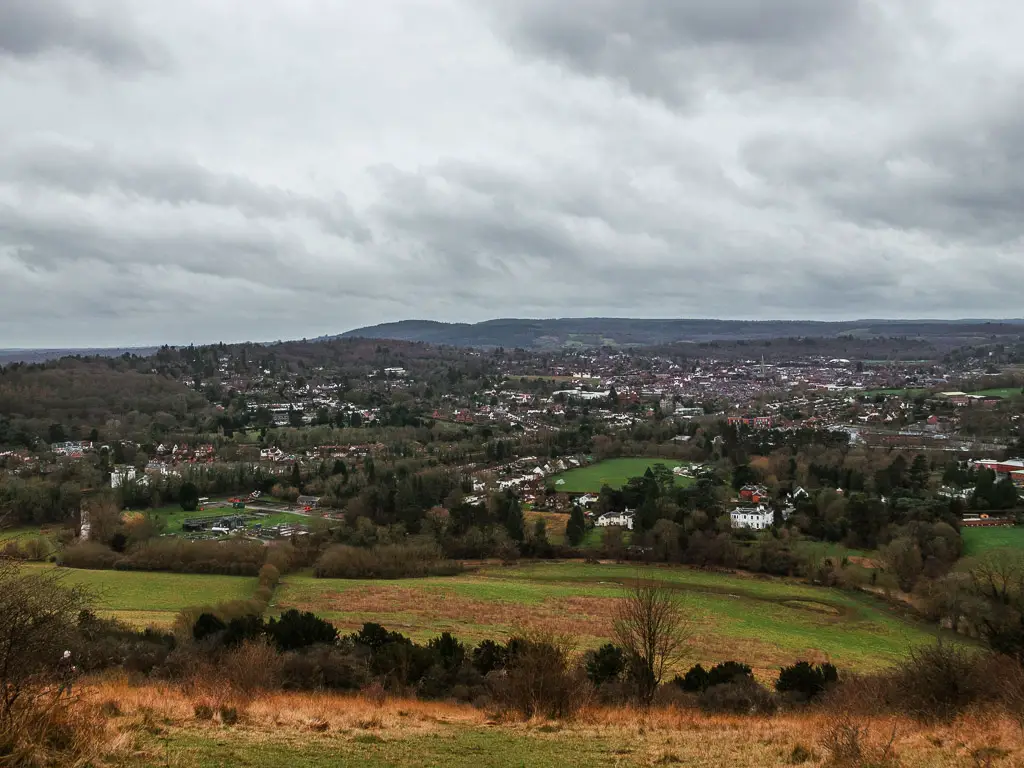 Looking at the view of thew hills and villages from Box Hill viewpoint on the walk from Westhumble Merstham along stage 3 of the north Downs Way.