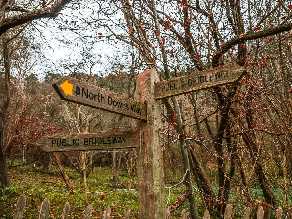 A wooden trail cross signpost saying 'North Downs Way' for stage 3 of the walk from Westhumble to Merstham.