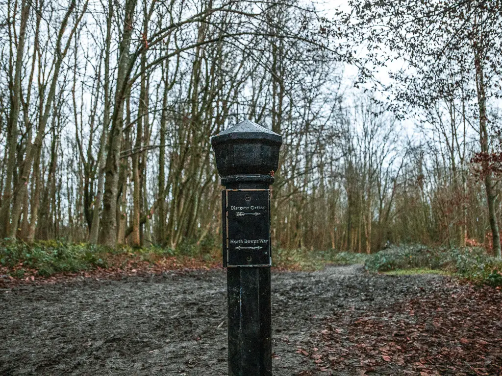 A black metal signpost marking the walk route for stage 3 of the north Downs Way.