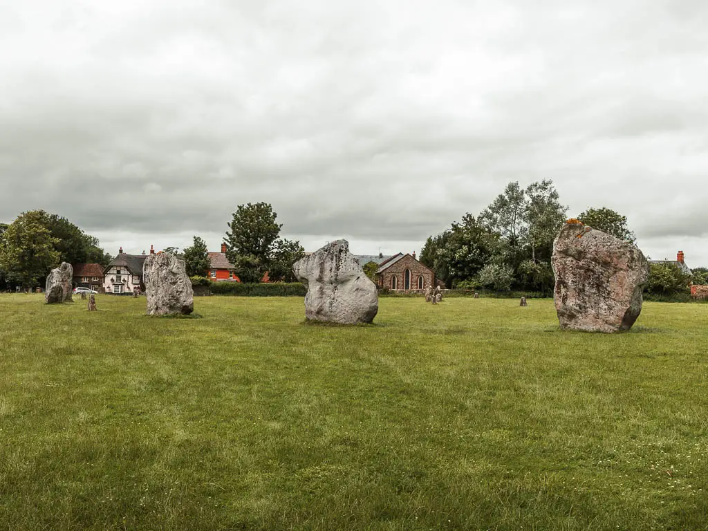 Four large stone circles in Avebury on the walk from Hackpen Hill. The stones are standing in a field.