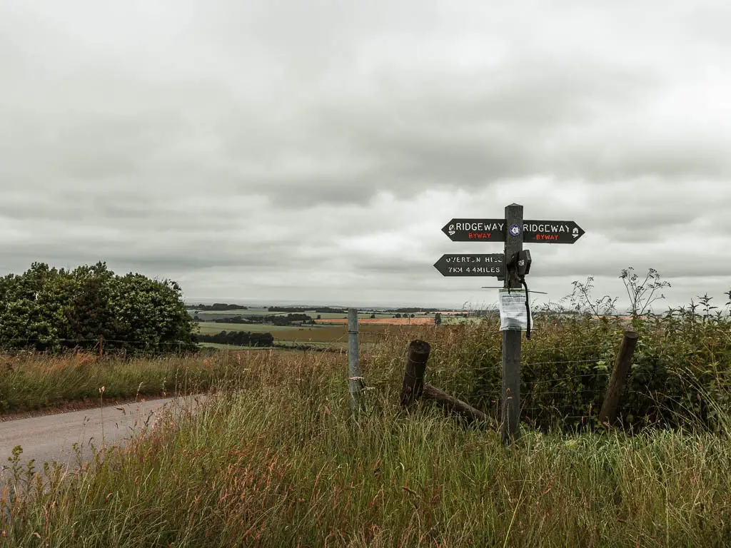 A wooden signpost saying 'Ridgeway' on the start of the circular walk along the Ridgeway towards Avebury.