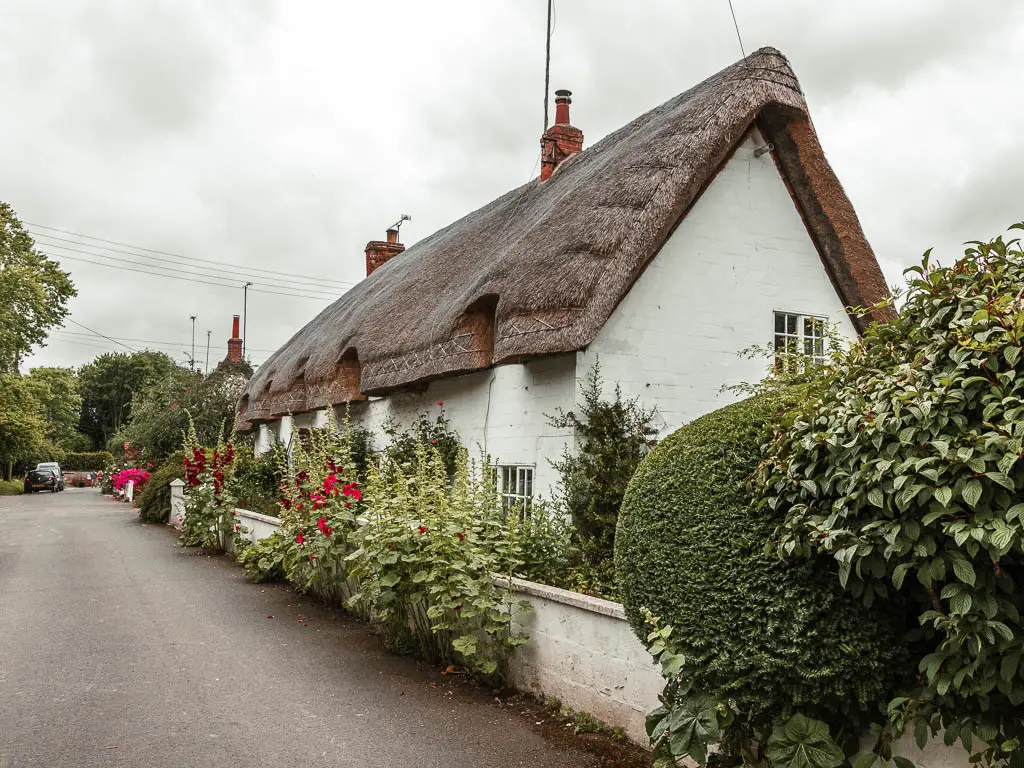 A white coloured cottage with a thatched roof in Avebury.