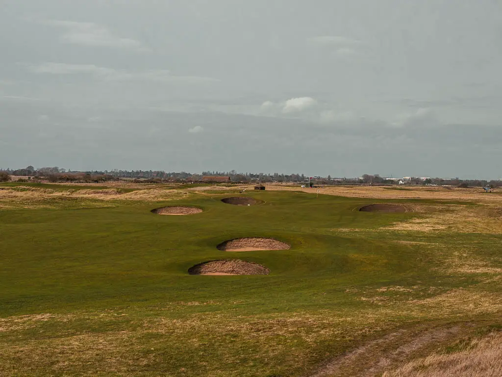 A golf course with a few circle sand bunkers on the walk from Deal to Sandwich.  