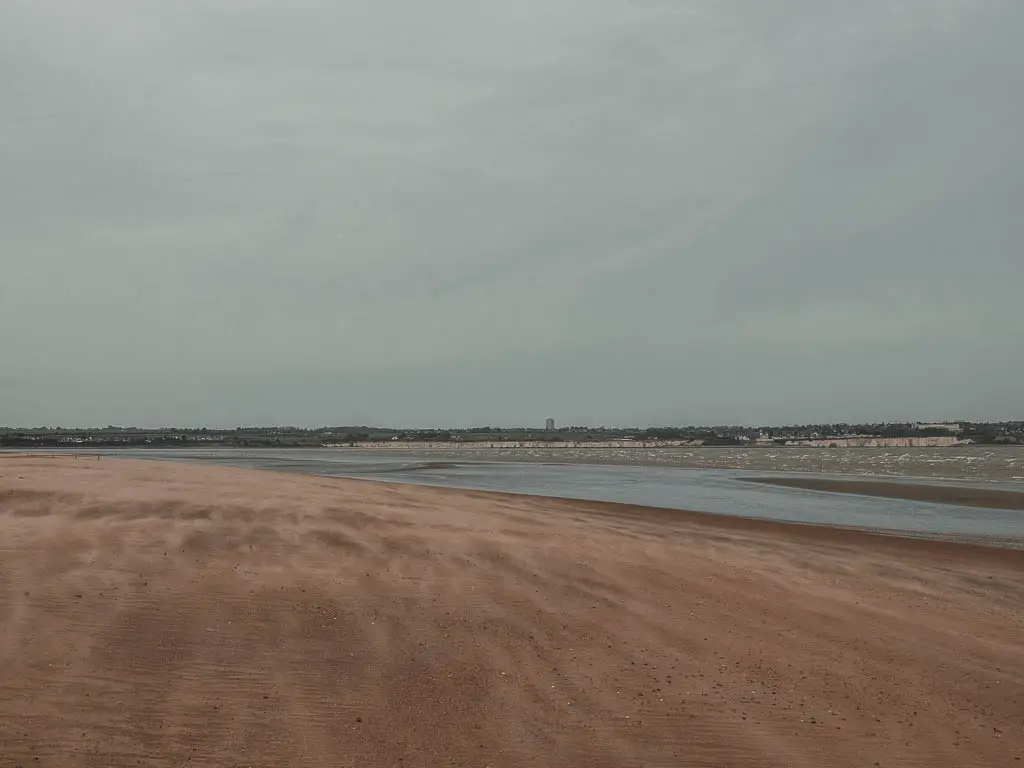 A sandy beach next to the water on the walk from Deal to Sandwich. 