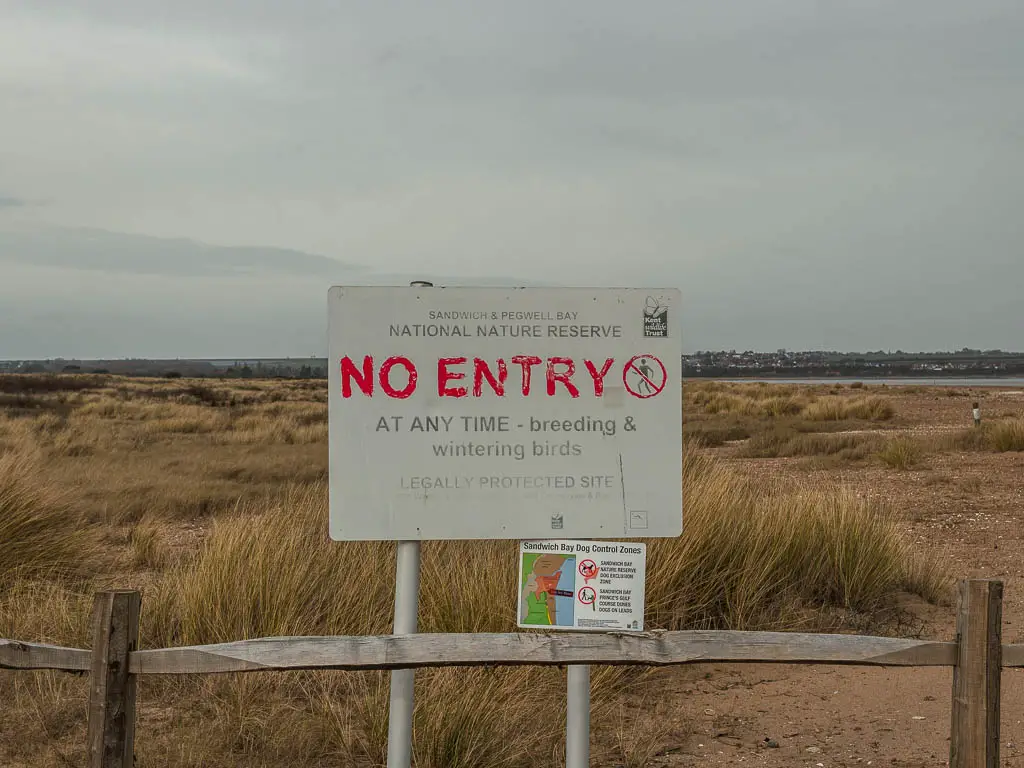 A sign saying 'No Entry' in red next to the Pegwell Bay Nature Reserve on the walk from Deal to Sandwich. 