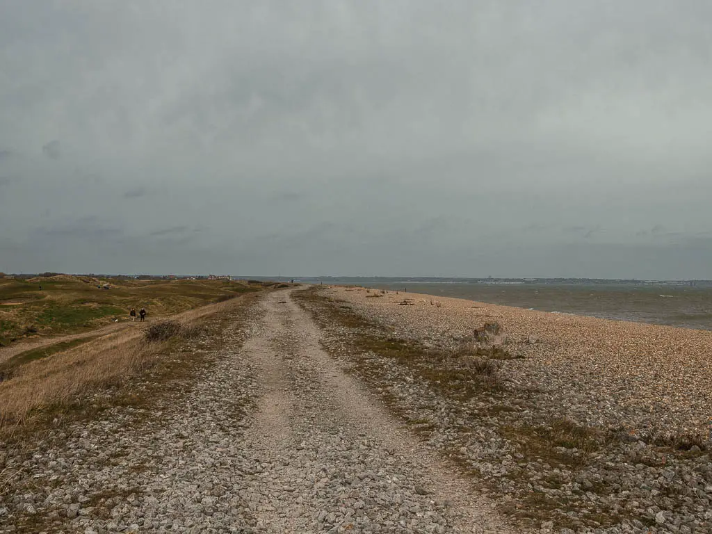 The shingle path next to the shingle beach on an overcast day.