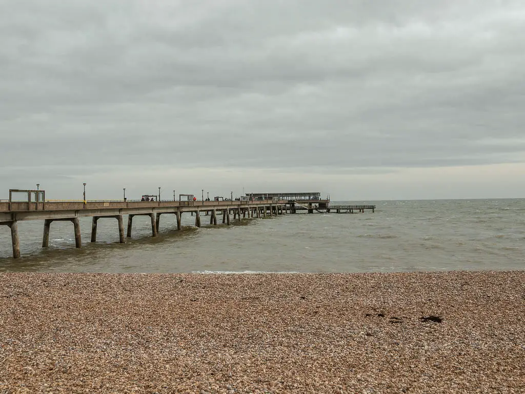 Deal pier stretching out across the water at the start of the walk towards Sandwich. The beach is shingle. 