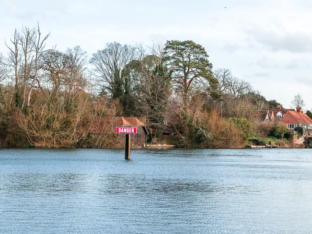 A red danger sign in the middle of the River Thames. 