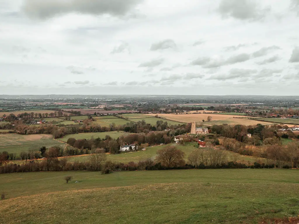 Looking down off Beacon hill on the walk from Wendover and Coombe Hill. The view is of fields as far as the eye can see with trees lining some of the fields.