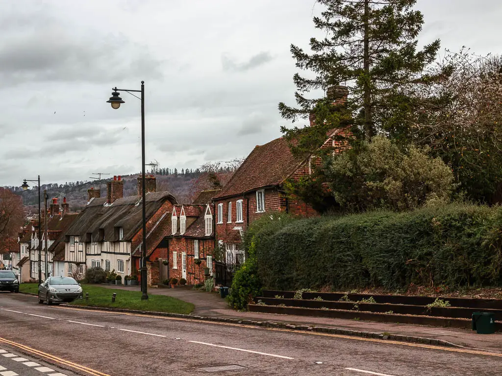 A trees lined with red bricked houses and thatched roofed houses on the walk from Wendover to Coombe hill and Beacon hill.