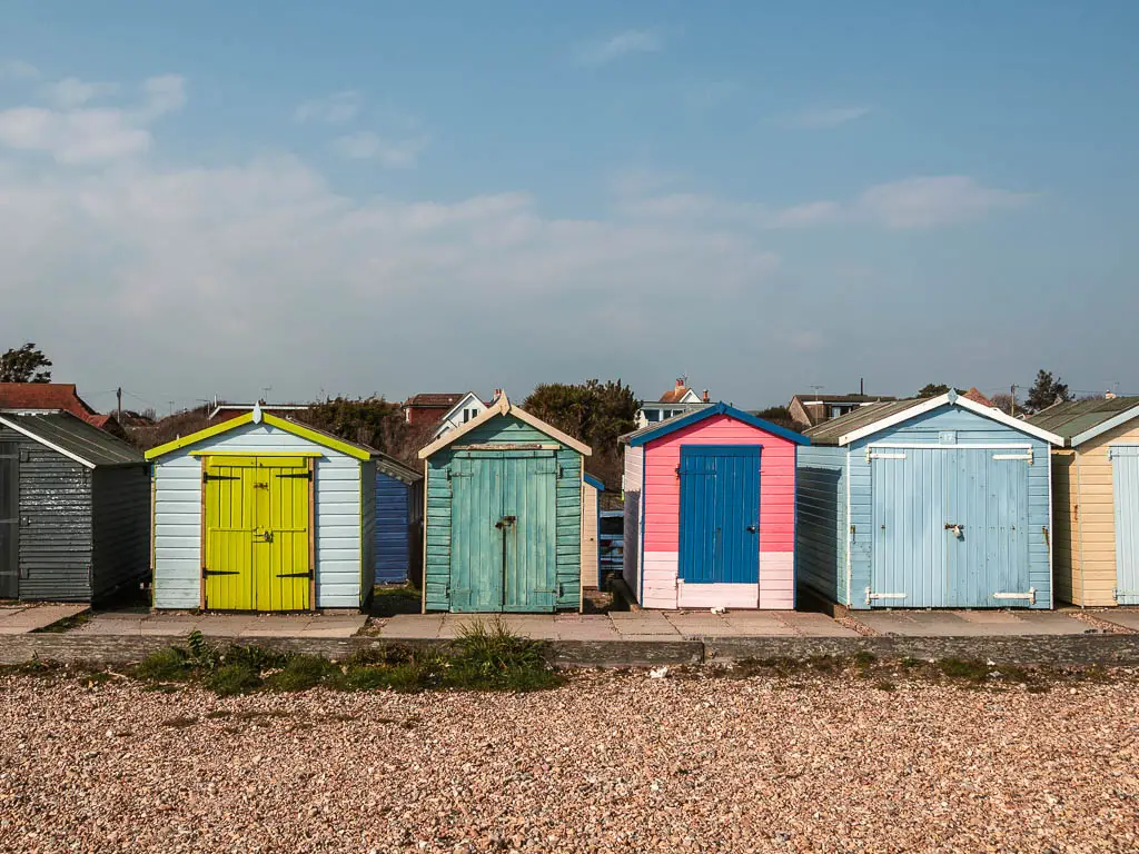 Shabby chic colourful beach huts on the coast path walk to Worthing from Littlehampton. 