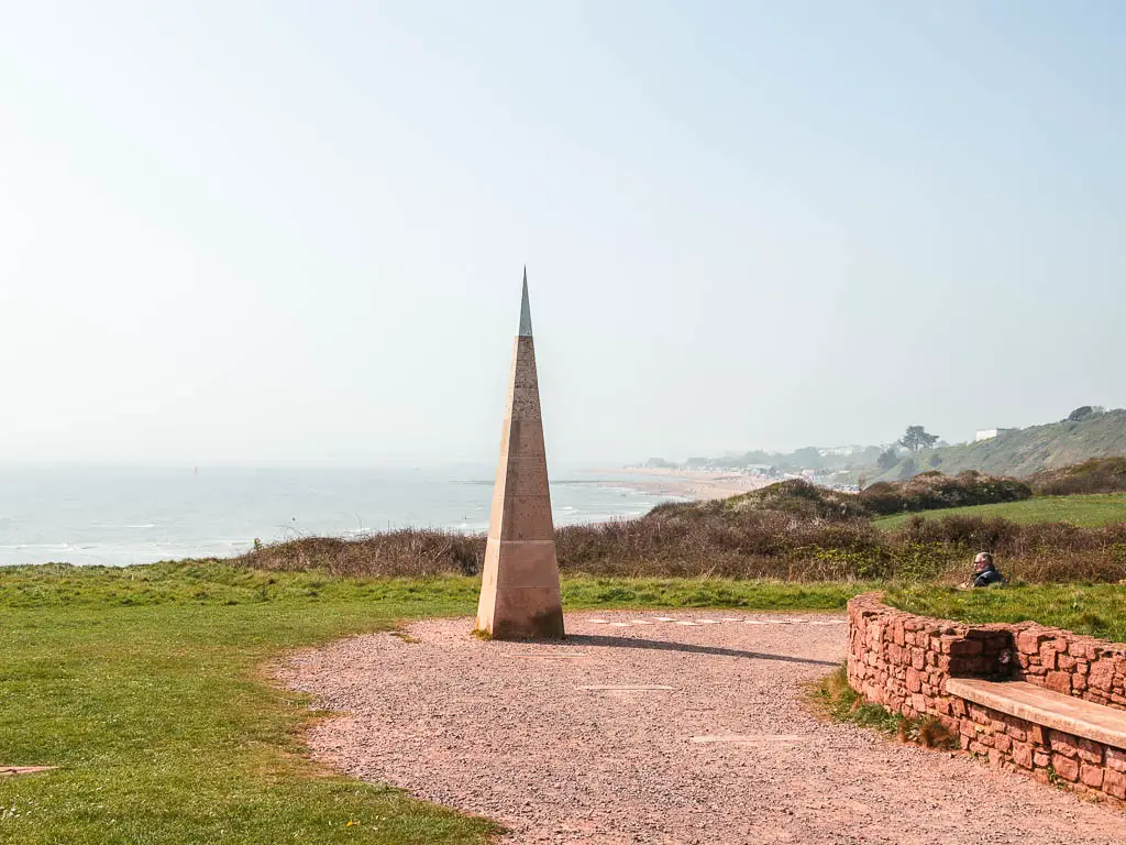 The needle of Orcombe Point with a view of the sea and Exmouth beach behind, on the coastal walk to Budleigh Salterton.