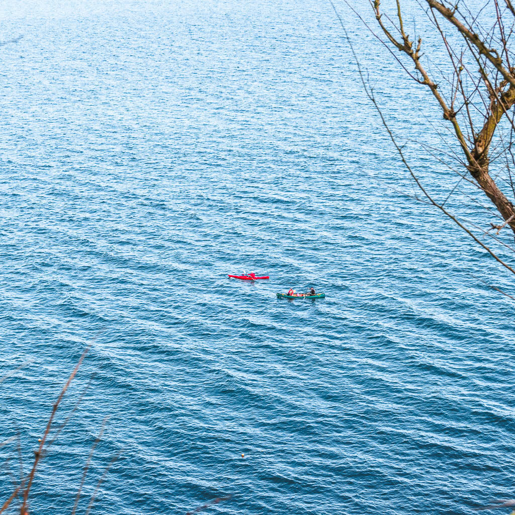 Two kayakers in the blue sea.