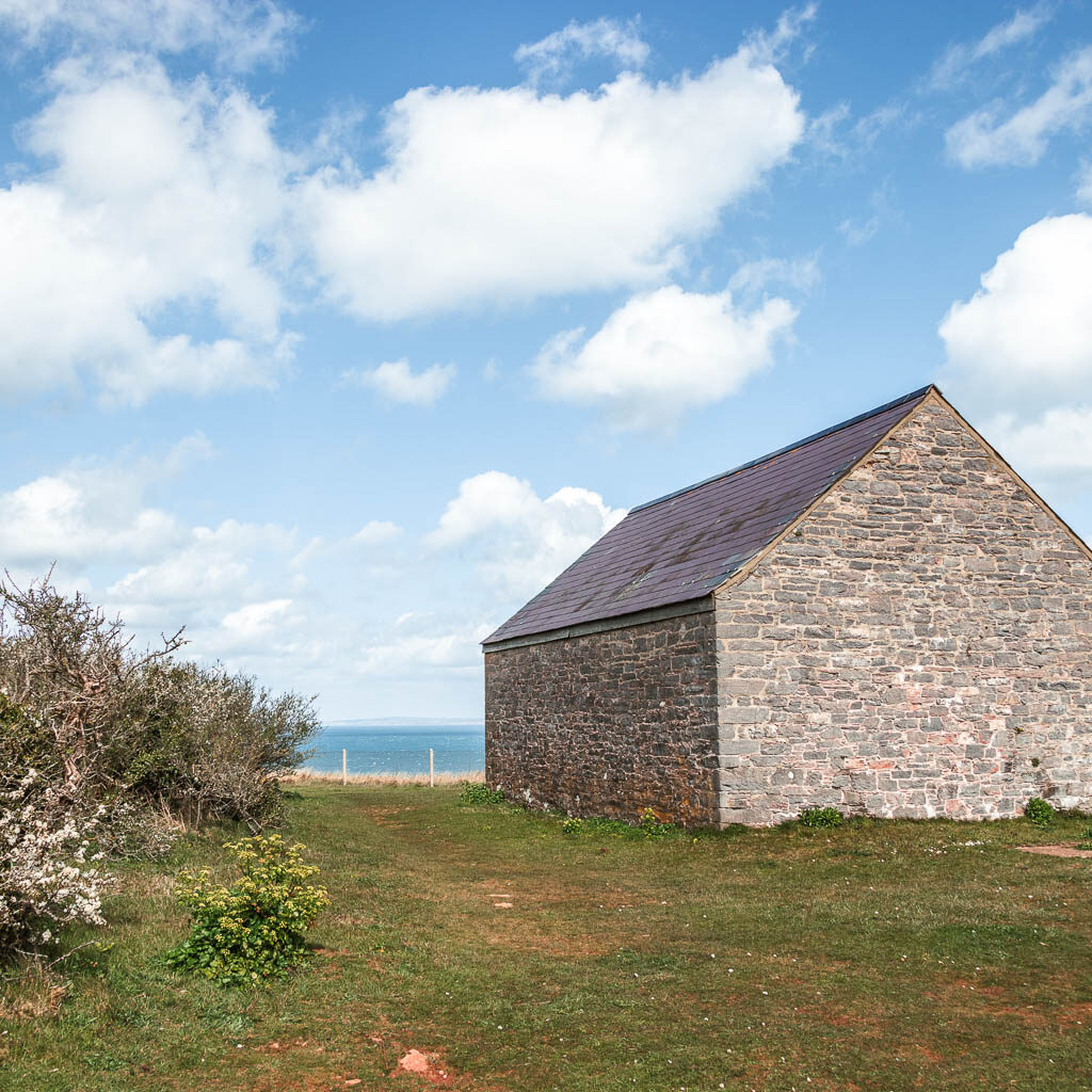 A stone hut on the green on the circular walk around Berry Head from Brixham.