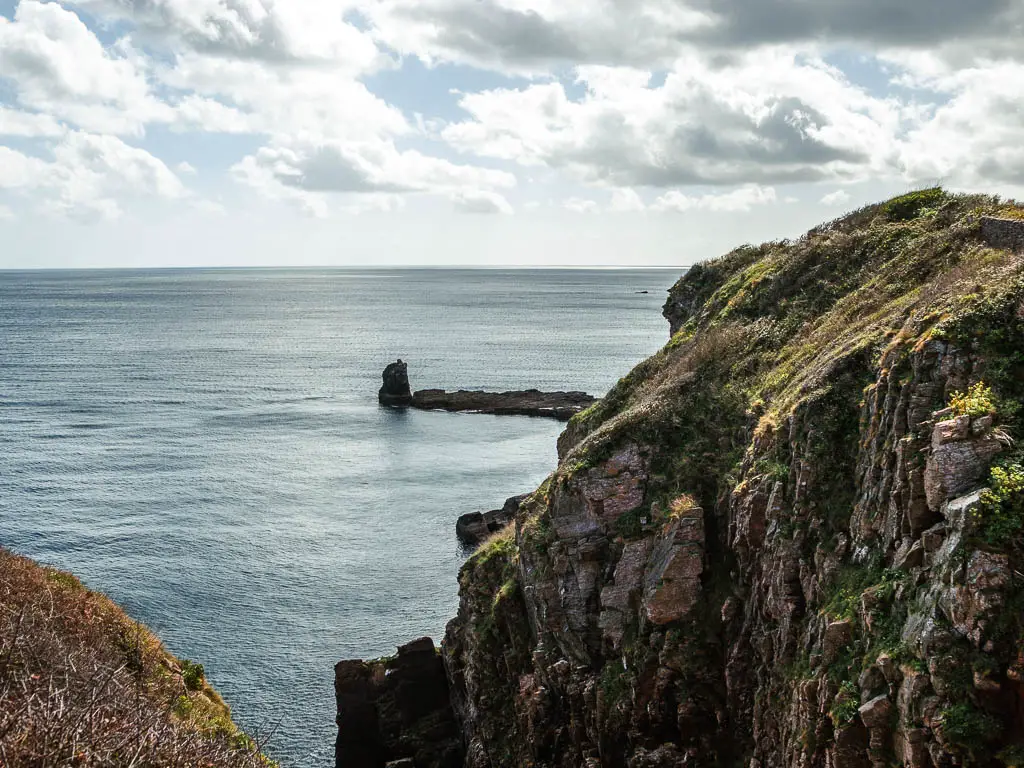 Looking down to the rugged cliff next to the sea on the circular walk from Brixham Harbour to Berry Head.