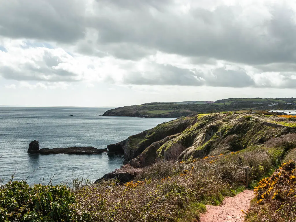 Looking down and along the rugged coastline where it meets the sea.