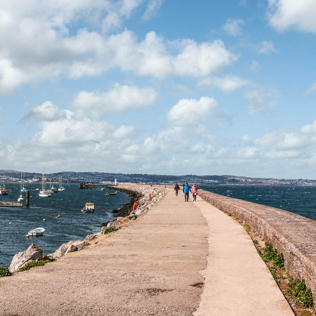 A long curved walkway next to Brixham Harbour after the walk to Berry Head.