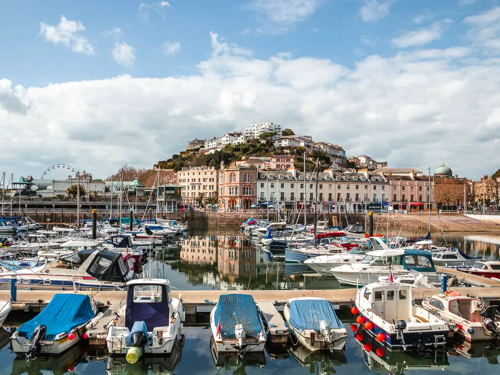 Looking across the boat filled harbour of Torquay, to a hill with houses on the other side, along one of the walks from Torquay.
