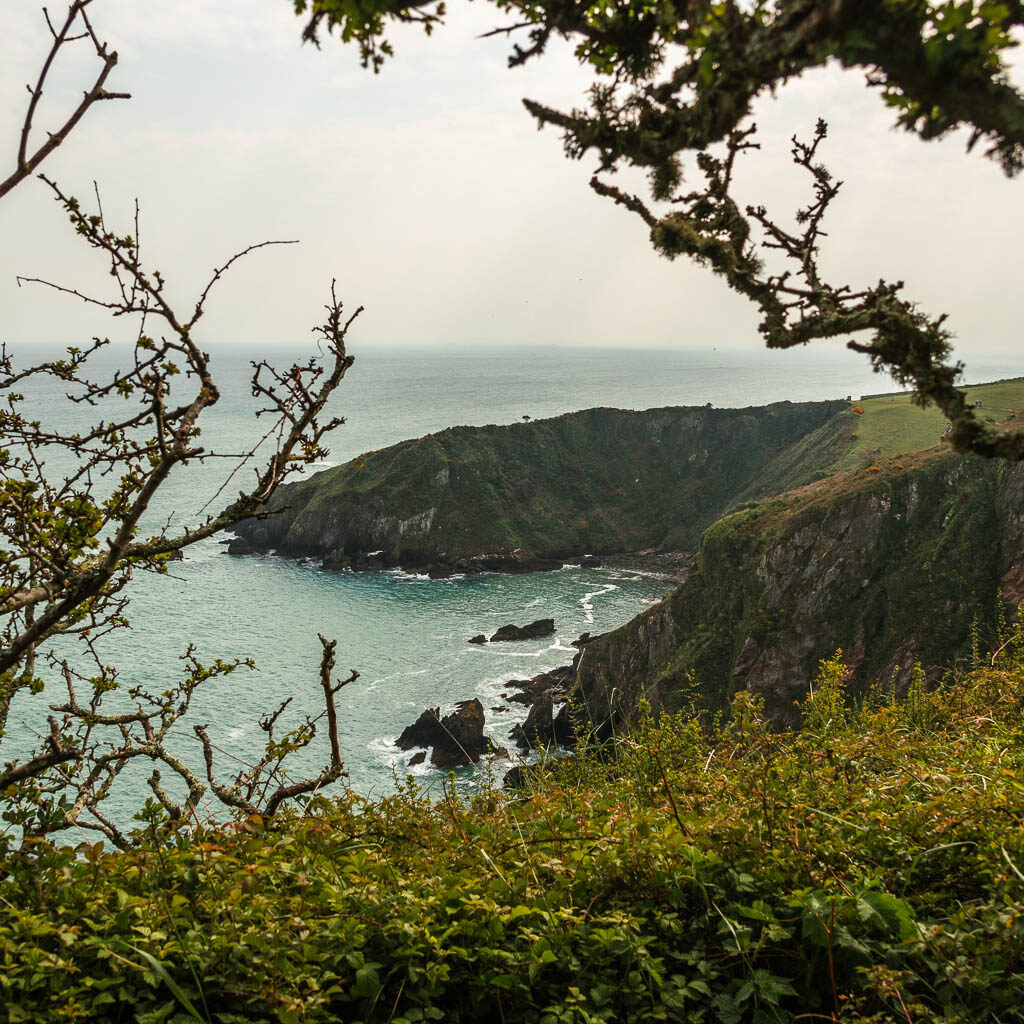 Looking down to the sea and a peninsular as it forms a cove. 