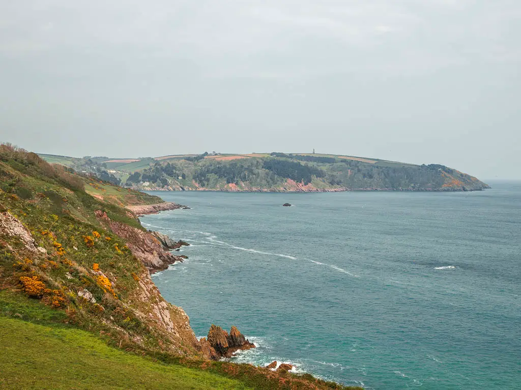 Looking along the hilly cliff coastline on the coastal walk from Dartmouth to Blackpool Sands.