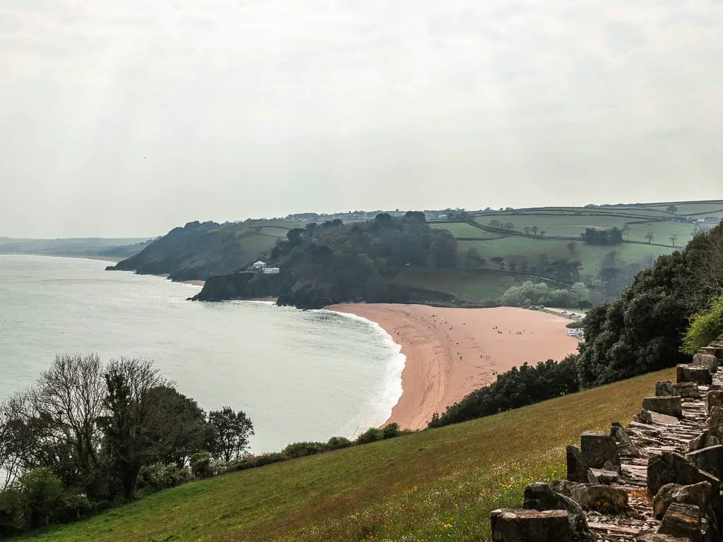 Looking down to the curved bay of Blackpool Sands beach near the end of the walk from Dartmouth. 