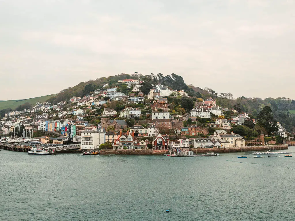 Looking across the river, to the big hill of Kingswear on the other side on the walk from Dartmouth to Blackpool Sands. There are lots of houses on the hill. 