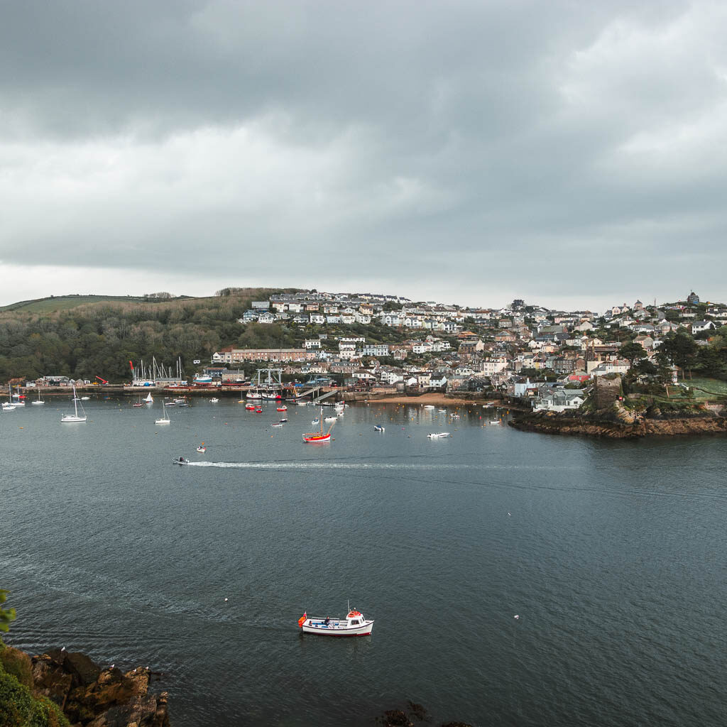 Looking down to the dark blue water of Fowey Harbour with lots of boats.