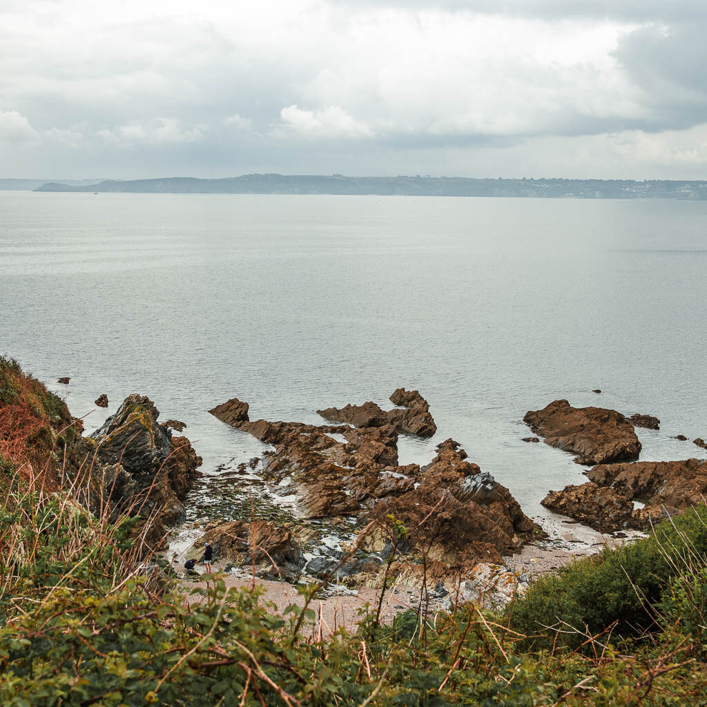 Looking down to the rocks leading into the sea on the coastal walk from Par to Fowey.