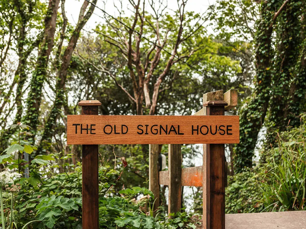 A wooden sign saying 'The Old Signal house'.