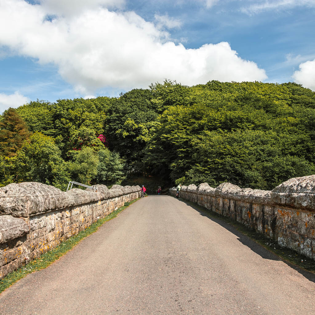 A wide road lined with stone walls.