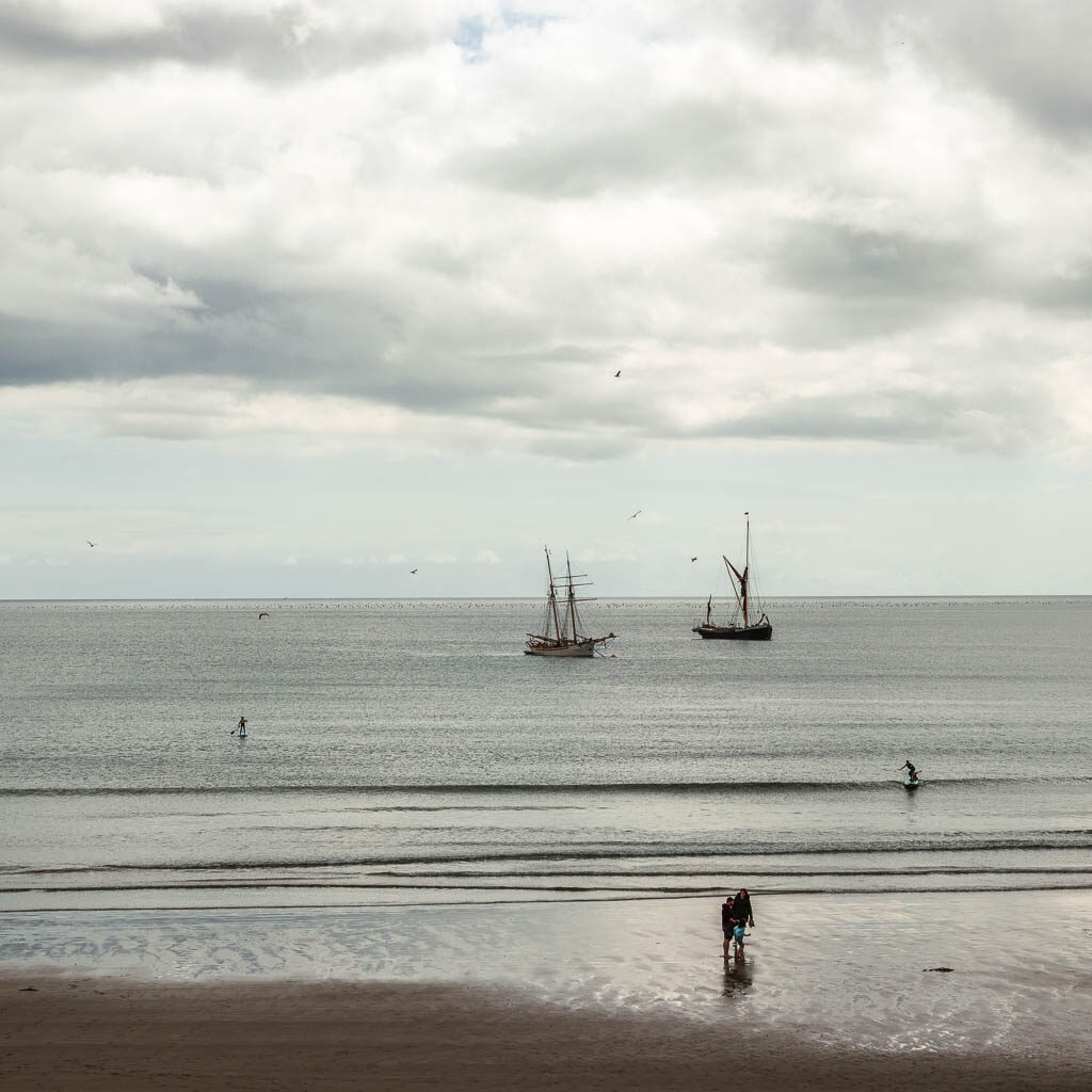 A couple of ships out to sea in the distance. 