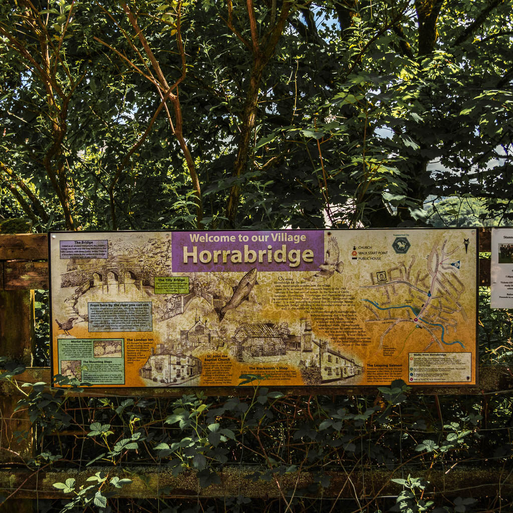 An information boards on a wooden fence, for Horrabridge.