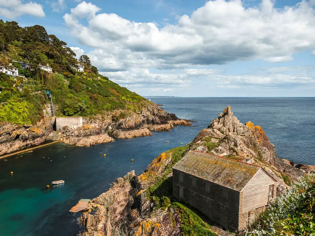 Looking down at the sea entrance into Polperro, at the end of the walk from Fowey. There is a pointy rock and shed on this side of the water