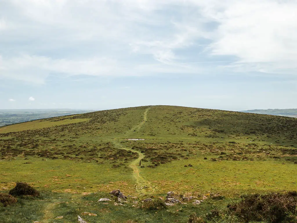 Looking down the hill and to the hill on the other side, with a. grass trail running straight across, on the Ivybridge to Western Beacon walk.