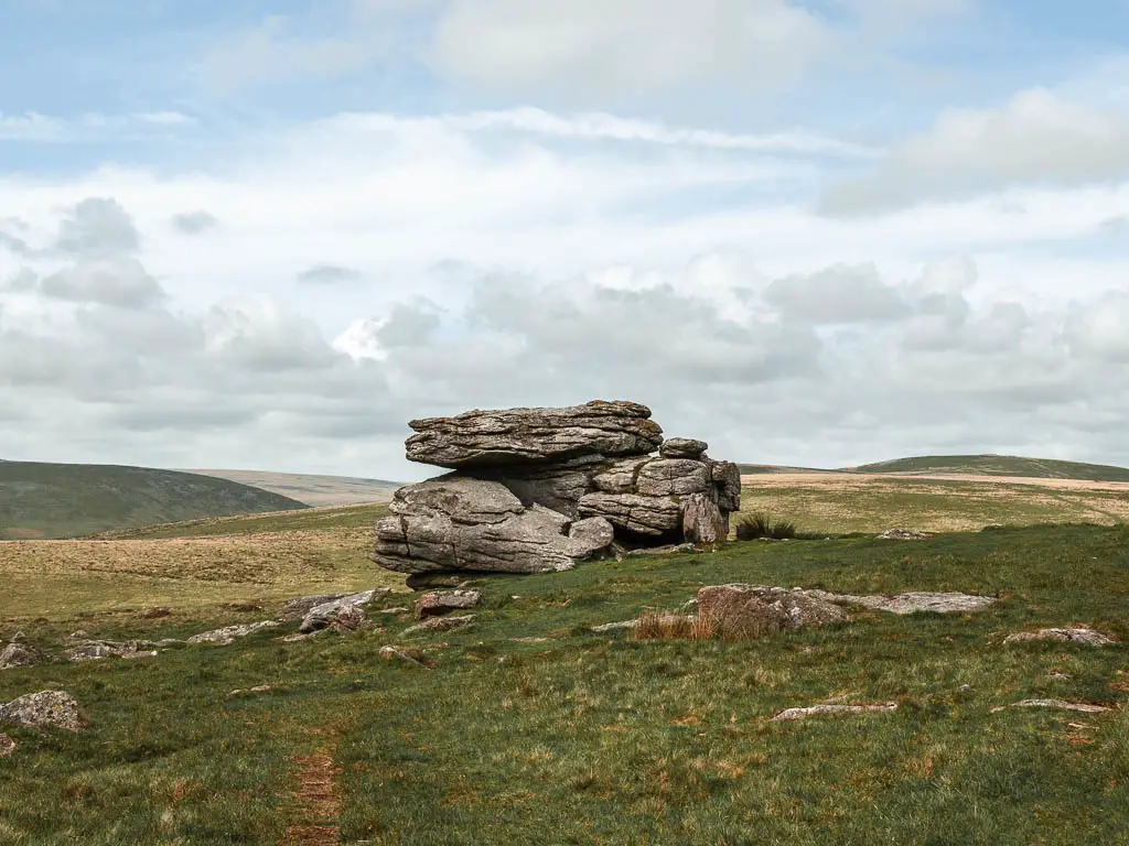 Looking across the grass to a tor on the Ivybridge and Western Beacon, Redlake Tramway circular walk.