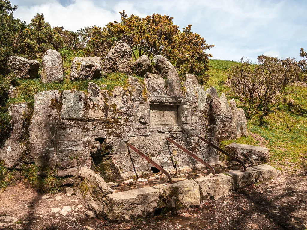 A rock structure in the side of the hill.