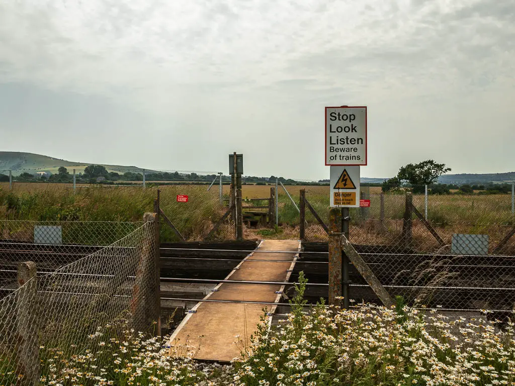 A path across a railway track on the walk towards the Long Man of Wilmington.